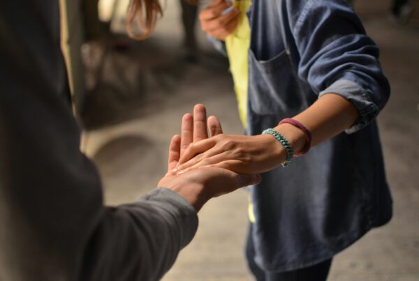 A person offering their hand in support. Mental Health Support