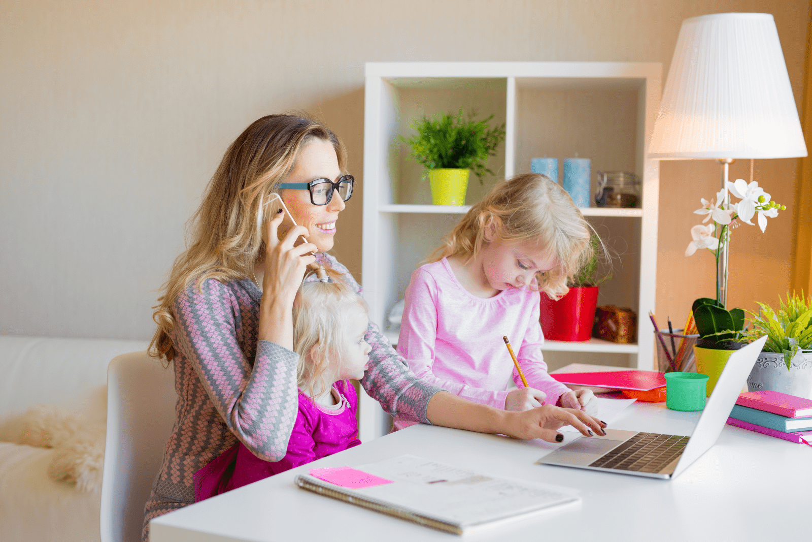 Mum working from home at the table, with her child.