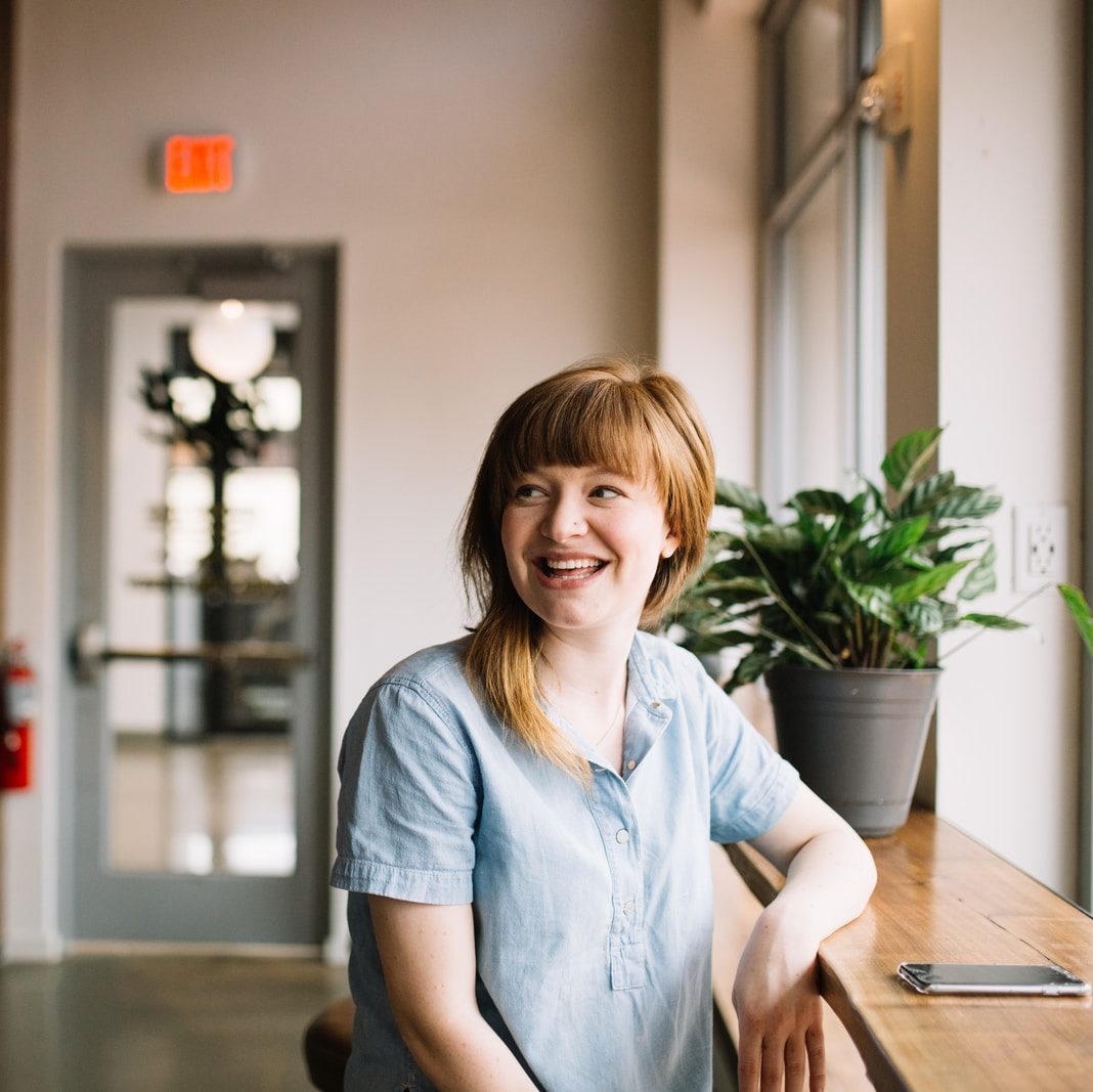 woman sitting in front of brown wooden table