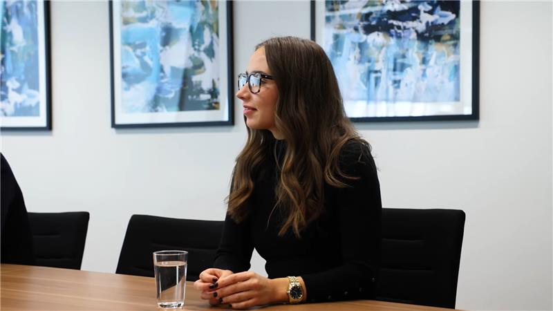 Expert recruitment consultant sitting at the boardroom table with a glass of water