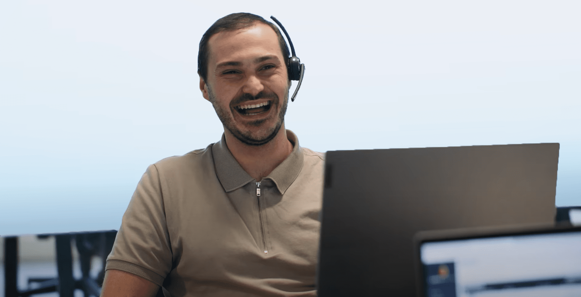 Expert consultant Charlie Hayden laughing at his desk while working