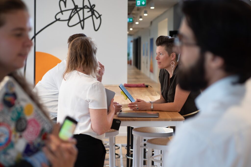 a group of people sitting around a wooden table