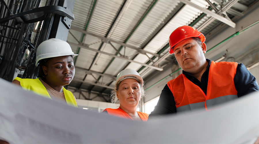 Group of people looking at a plan on a construction site