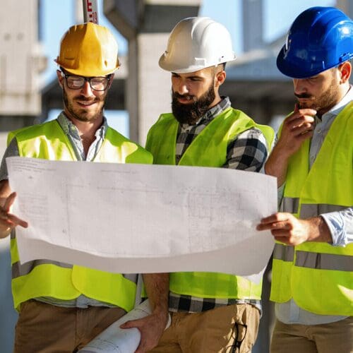 construction engineers looking at a blueprint