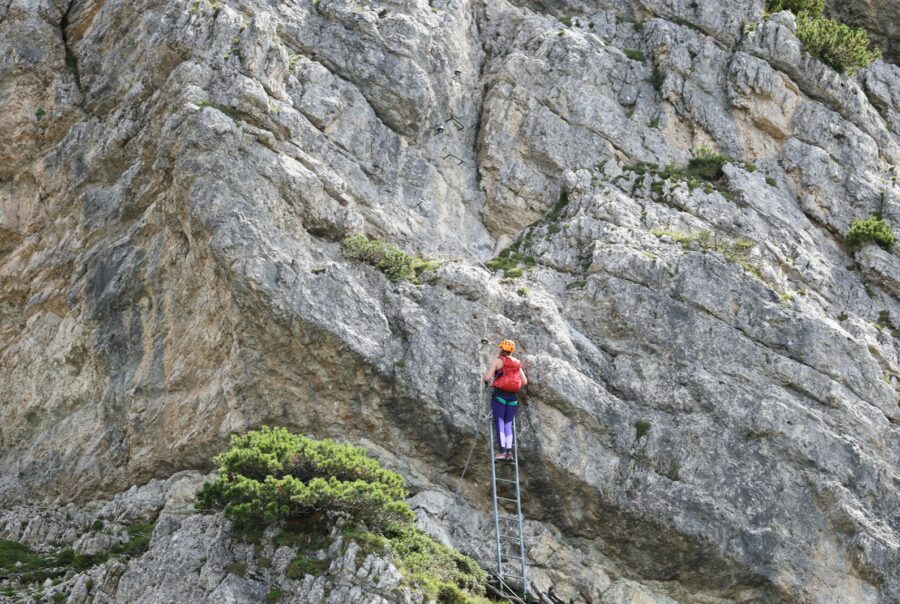 A person climbing up the side of a mountain